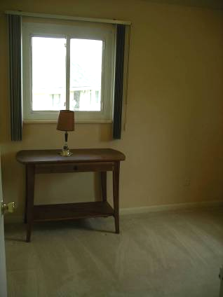 Left photo of second bedroom